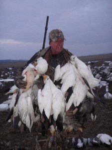 Happy hunter with a game strap full of snow geese.