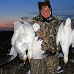 One of our many female hunters with some of the snow geese she harvested.